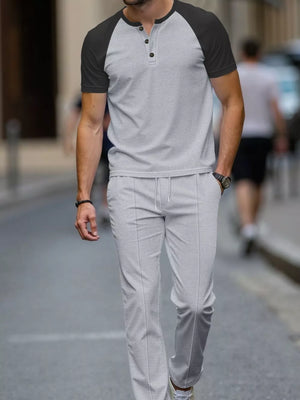 Men's grey two-piece loungewear set with a patterned henley shirt and drawstring pants.