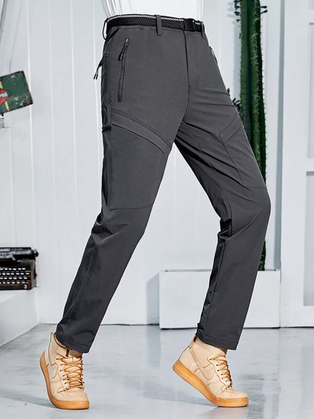 Men's grey sweatpants with zippered pockets and a quick-dry fabric.