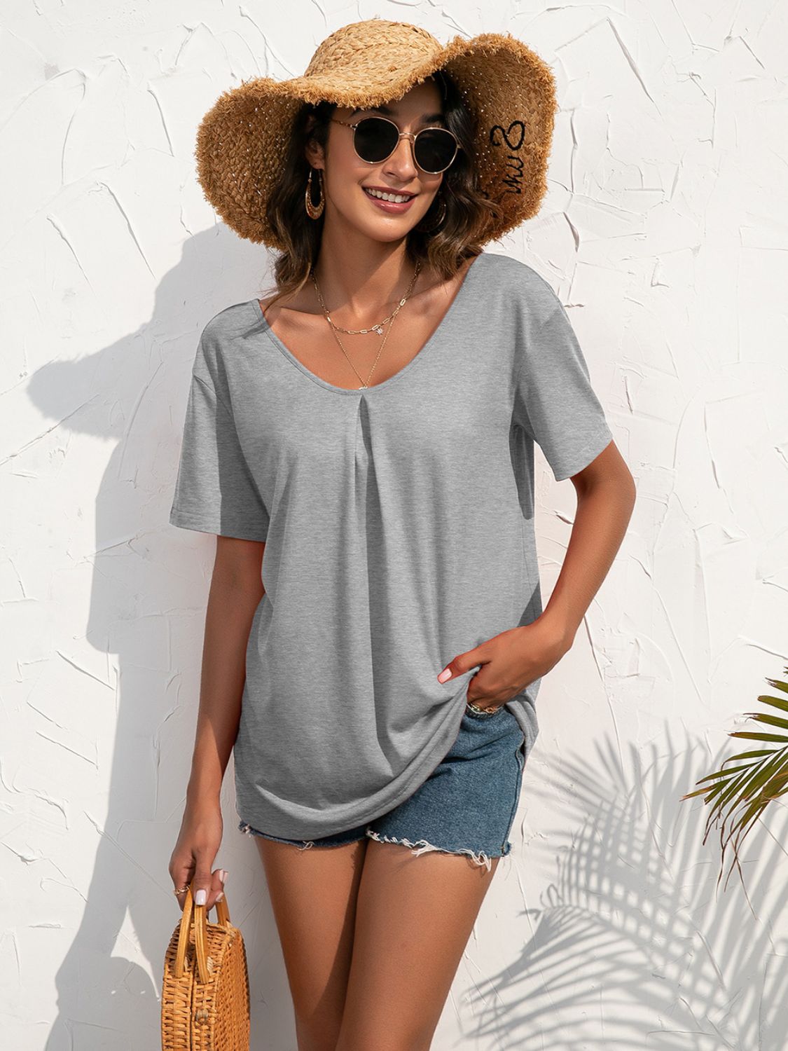 Grey v-neck t-shirt with short sleeves and a subtle front pleat detail.