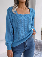 Azure cable knit sweater with square neckline and long sleeves, styled with jeans.