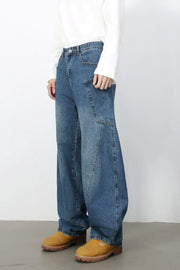Sculpted denim balloon trousers in medium wash with unique paneling and wide leg.