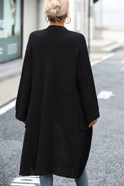 Black longline knit cardigan with pockets and a relaxed fit.