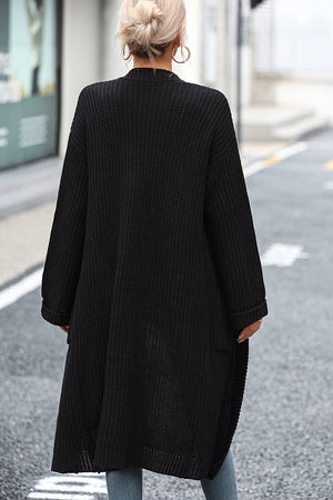 Black longline knit cardigan with pockets and a relaxed fit.