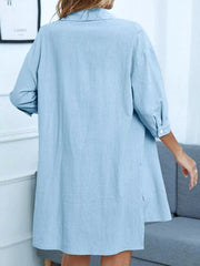 Light blue collared button-down shirt with cuffed sleeves and side slits, part of a two-piece set.