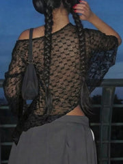 Black sheer lace one-shoulder cropped cardigan with intricate pattern.