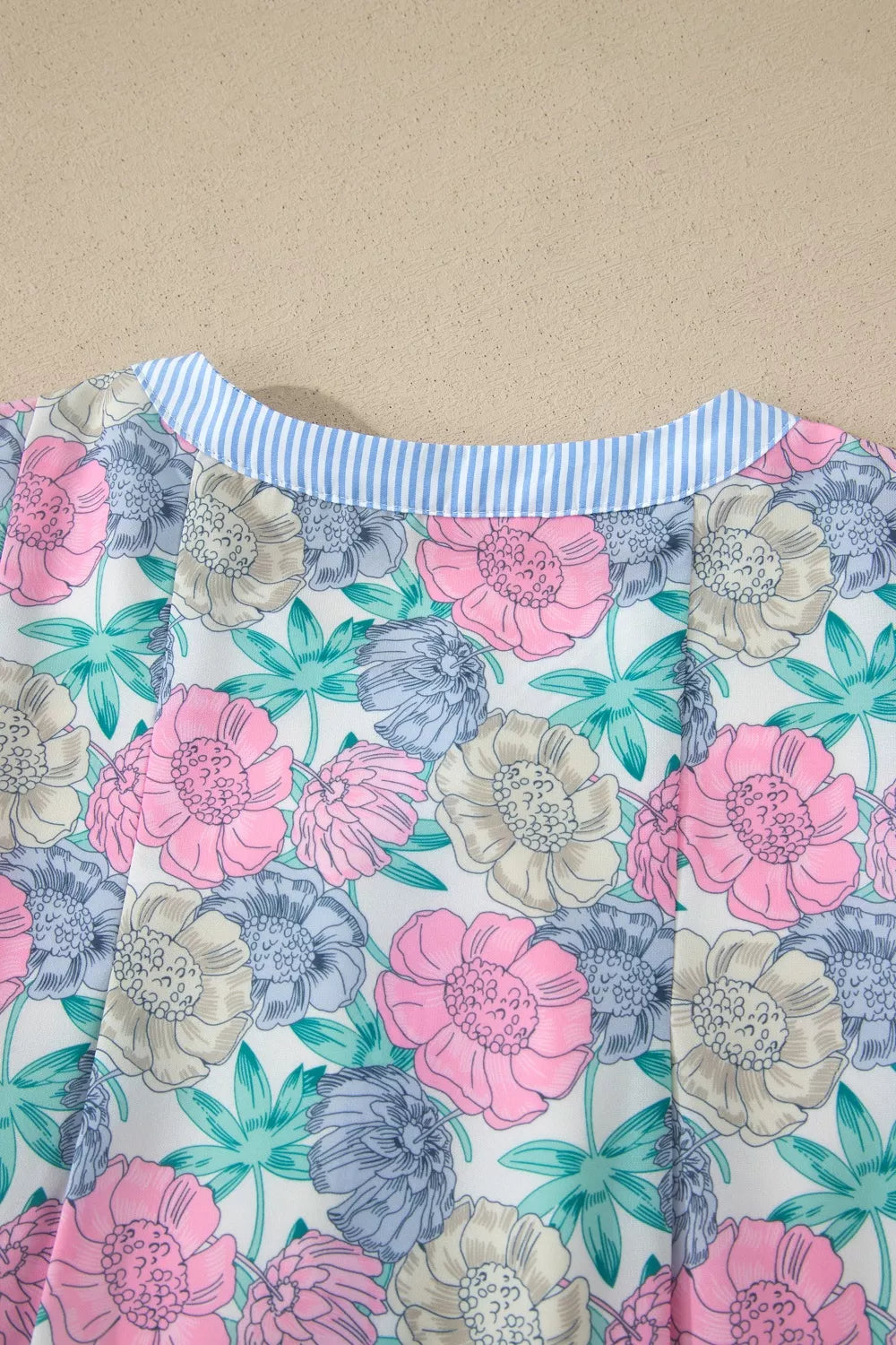 Floral mini dress with contrast blue striped collar and button front detail.