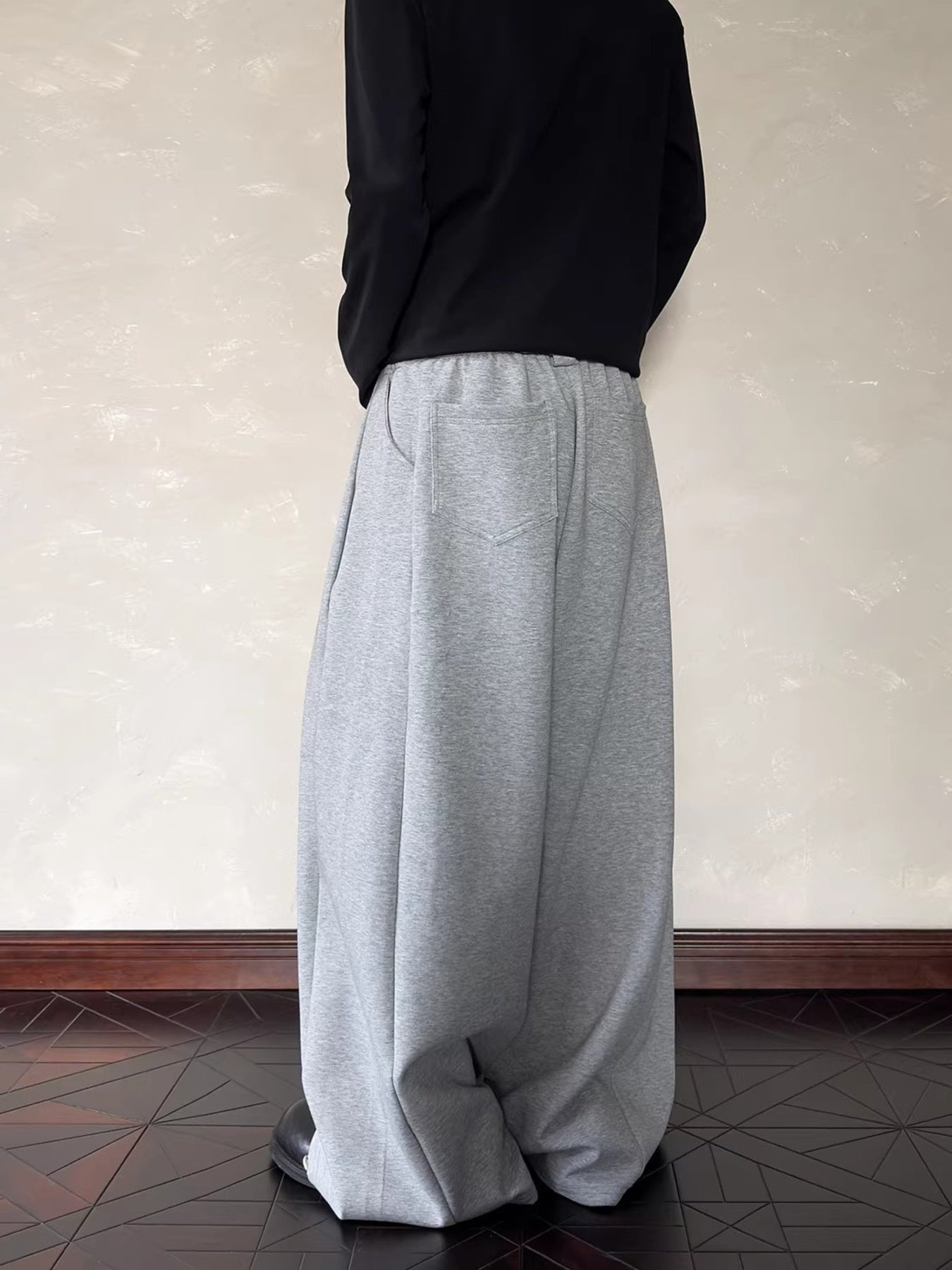 Men's relaxed fit grey sweatpants with elastic waist and back pockets.