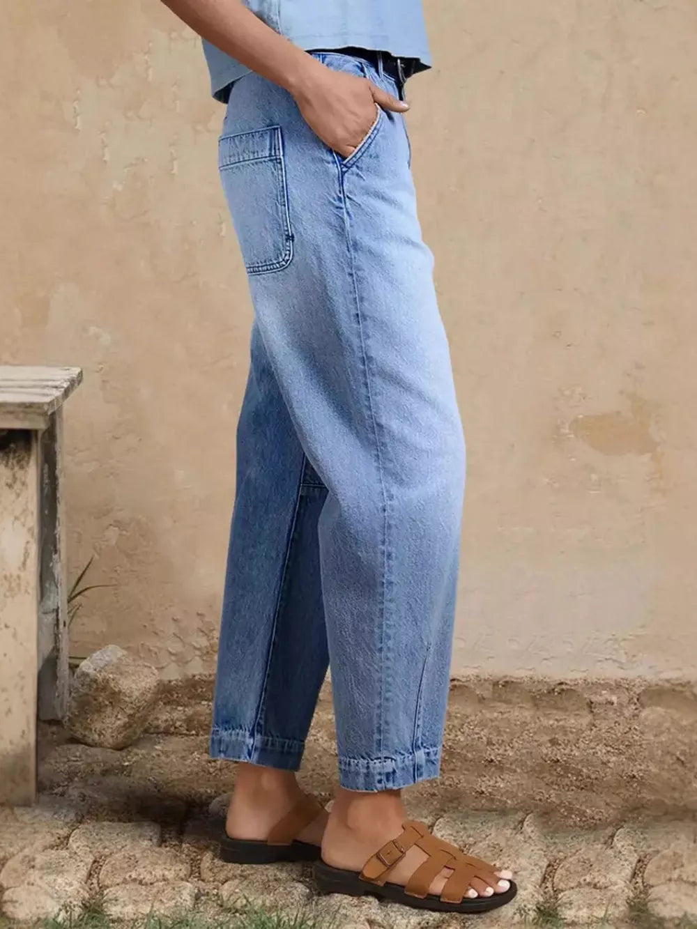 Relaxed fit light wash denim maternity jeans with cuffed hem and pockets.