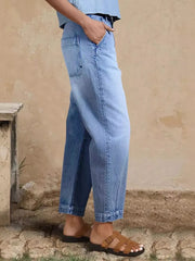 Relaxed fit light wash denim maternity jeans with cuffed hem and pockets.