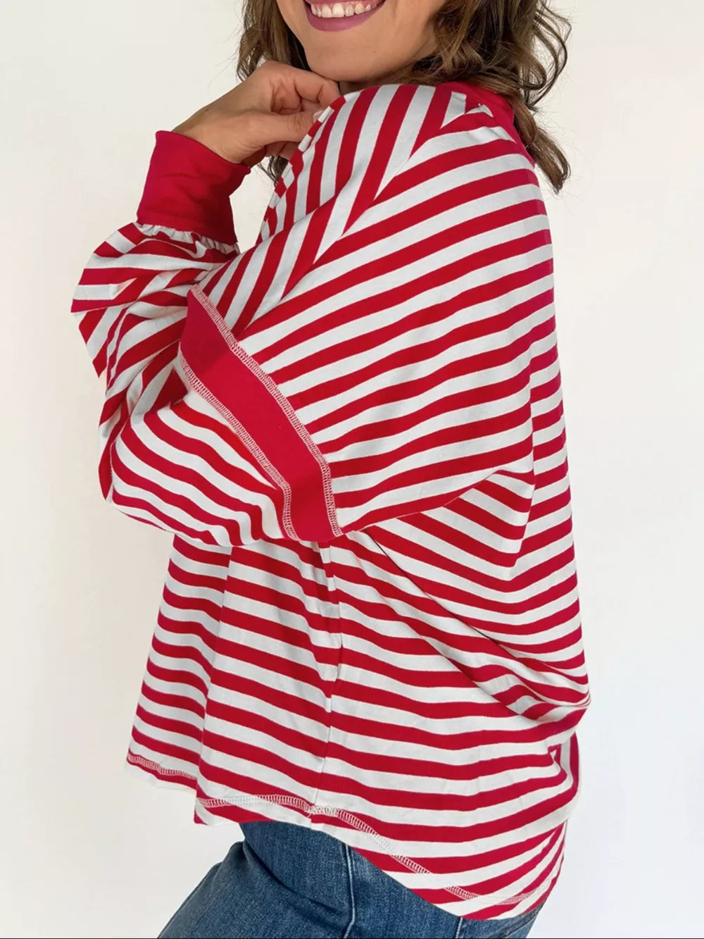 Red and white striped V-neck sweatshirt with cotton fabric and long sleeves.