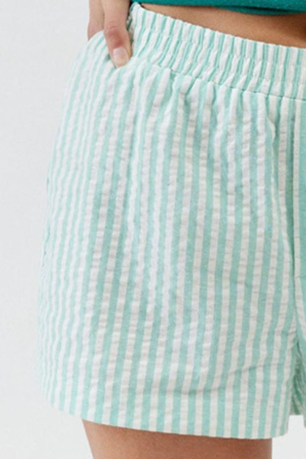 Seersucker boxer shorts in light green and white stripe with elastic waistband.