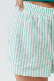 Seersucker boxer shorts in light green and white stripe with elastic waistband.
