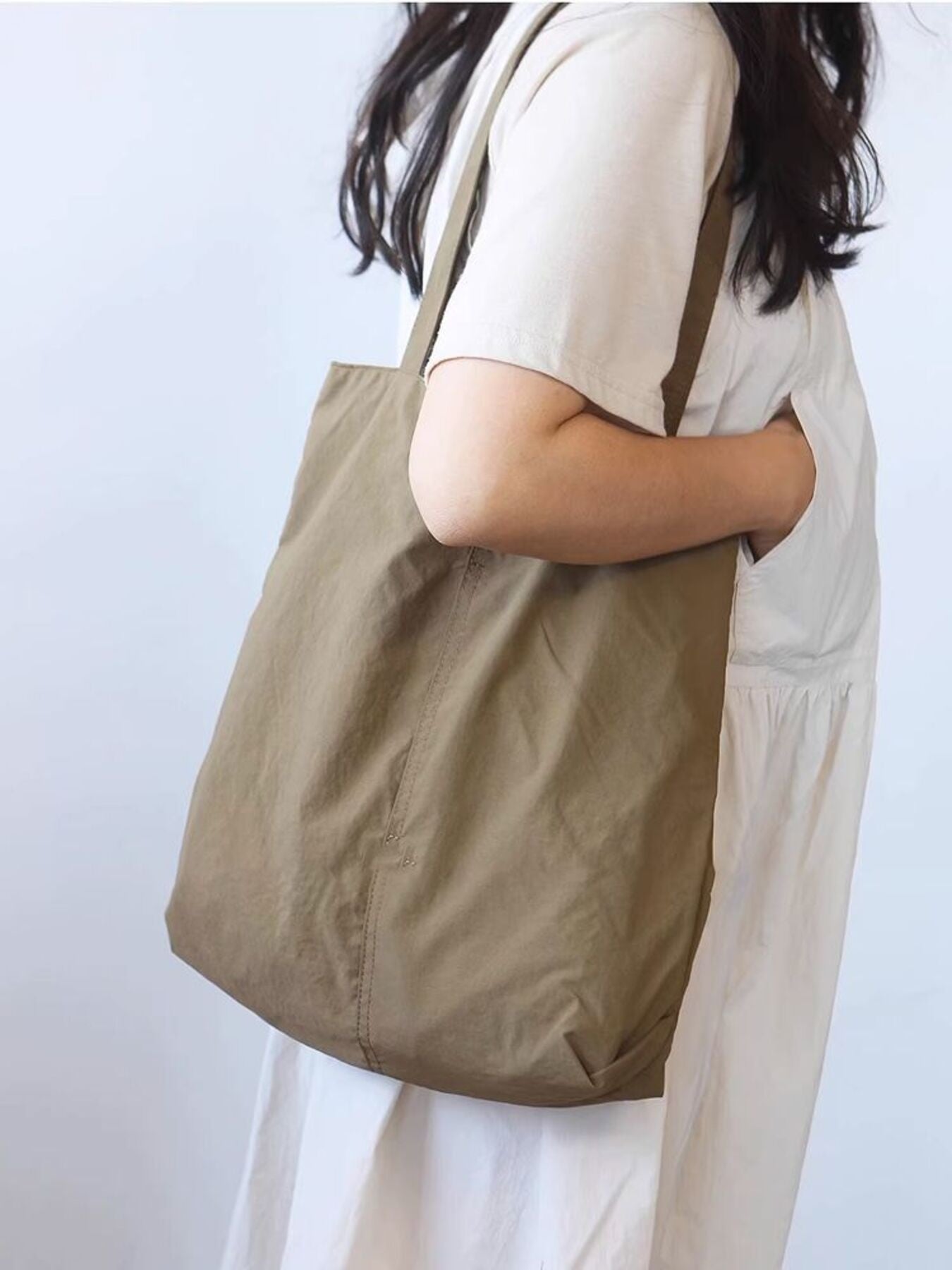 Spacious Khaki Nylon Shoulder Bag with slip pocket detail.