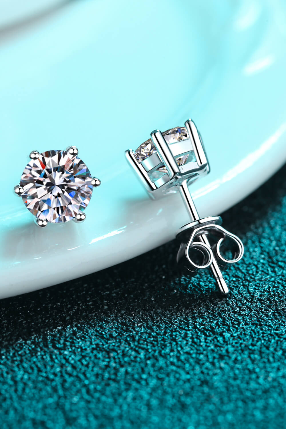 Silver six-prong solitaire stud earrings with sparkling cubic zirconia stones.