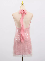 Pink sequin halter mini dress with sheer overlay and ribbon tie back.