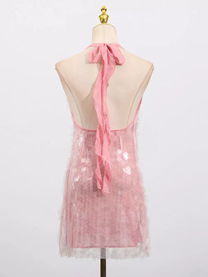 Pink sequin halter mini dress with sheer overlay and ribbon tie back.