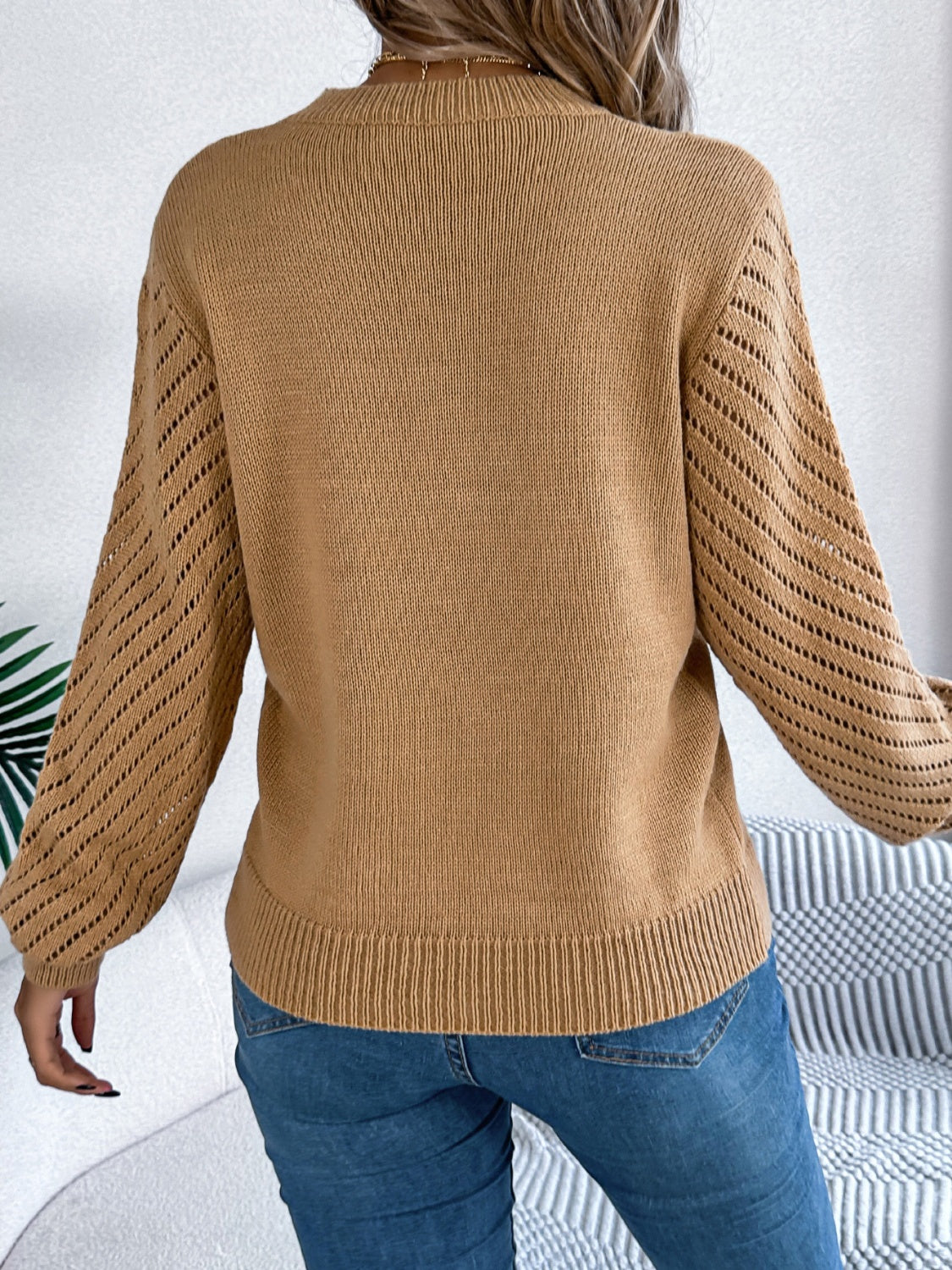 Camel openwork chevron knit blouson sleeve sweater with ribbed cuffs and hem.