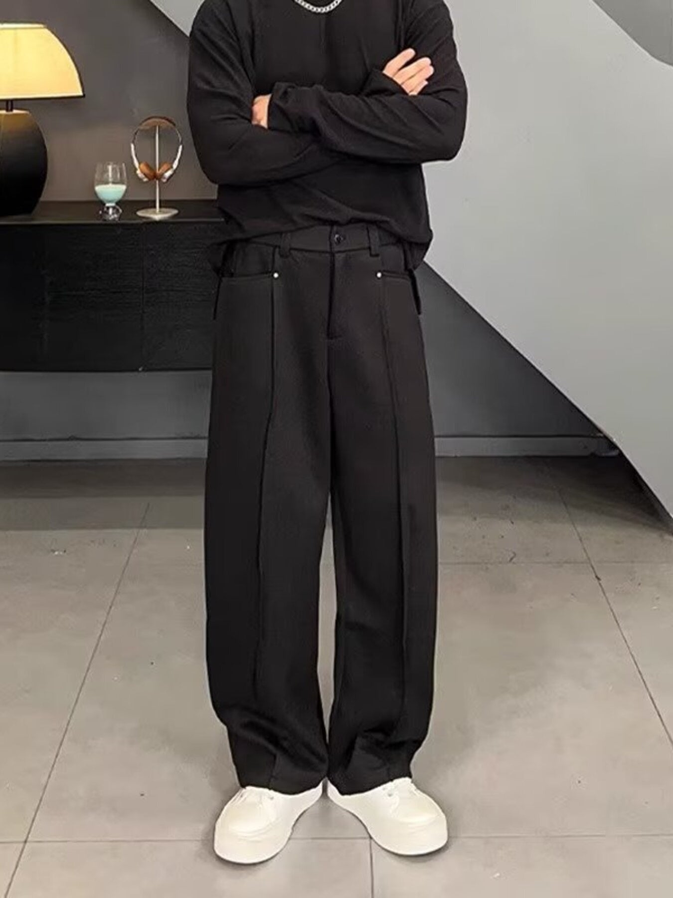 Men's black relaxed fit wide leg sweatpants with front seam detail.