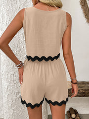 Tan sleeveless outfit set with black scalloped trim on top and shorts