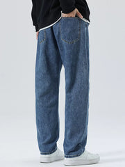 Men's light blue 100% cotton loose-fit jeans with drawstring detail and classic back pockets.