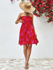 Smocked bandeau floral mini dress in red with pink flowers, A-line cut, strapless, cinched waist.