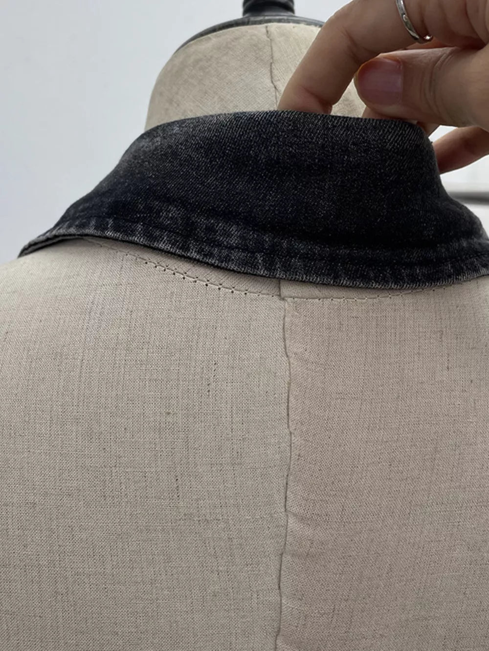 Gathered denim halter top with collar in black, showing collar detail and buttoned back.
