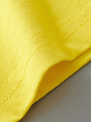Yellow cotton toddler tee detail with visible stitching