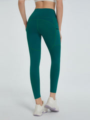 Dark green pocketed sculpt leggings with contrast stitching and a high waist.