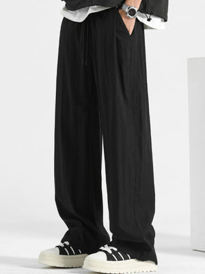 Black loose fit casual sweatpants with drawstring and elastic waistband.