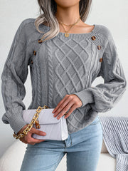 Cable-knit sweater in charcoal with buttoned shoulder detail and square neckline.
