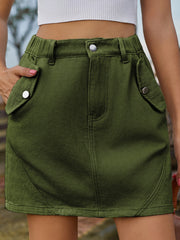 Army green utility pocket mini skirt with elastic waist and button closure.