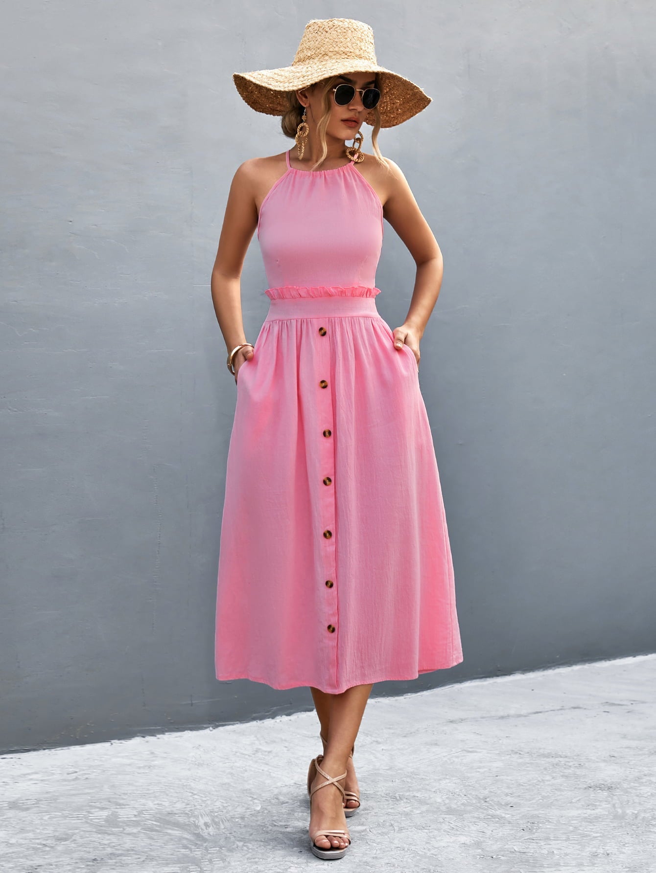 Pink button-down midi dress with halter neck and ruffled waist detail.