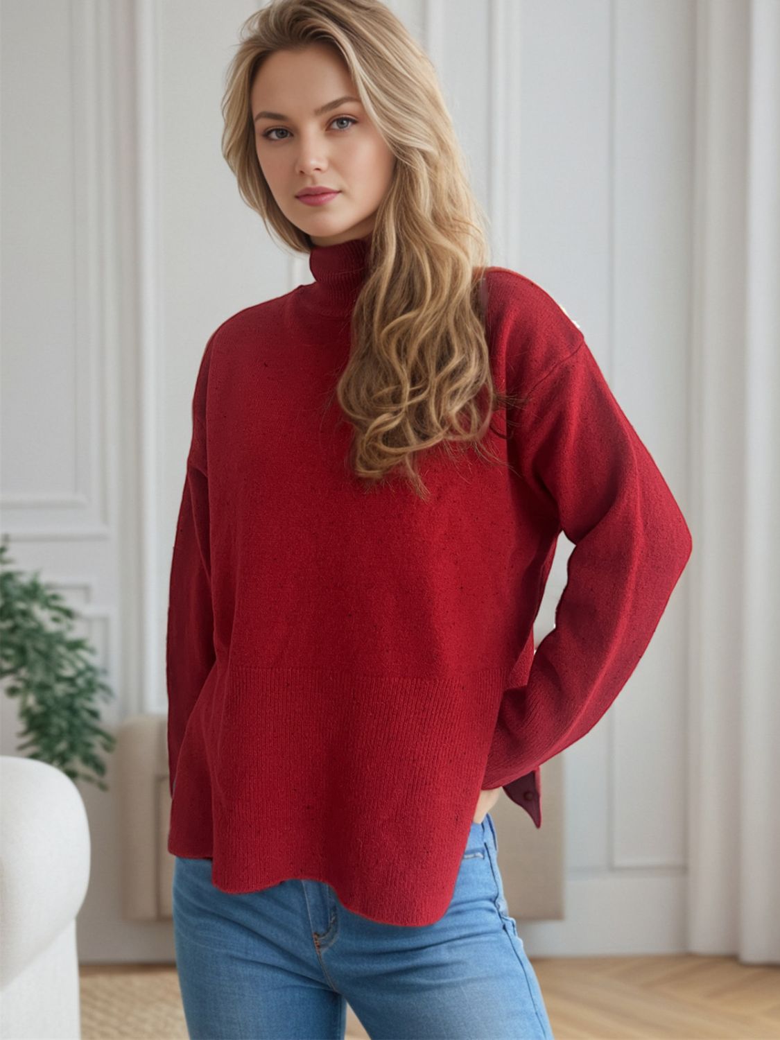 Scarlet turtleneck knit sweater with ribbed hemline and slit sides.