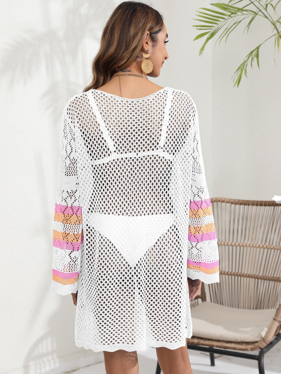 White crochet cover-up with striped sleeves and open knit detail.
