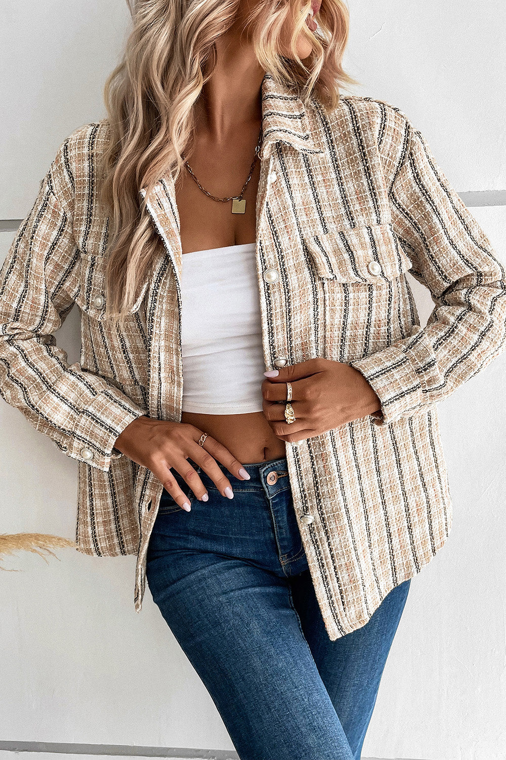 Textured tweed shirt jacket in tan with pearl button pockets and collar.
