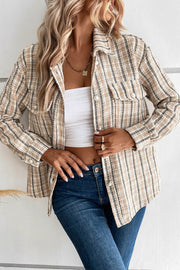 Textured tweed shirt jacket in tan with pearl button pockets and collar.