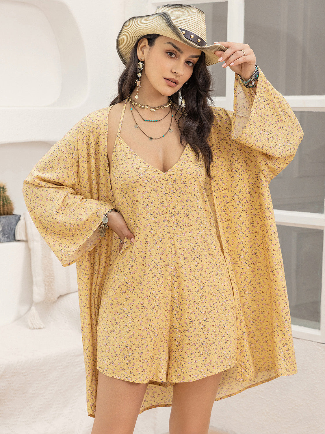 Yellow floral romper and kimono cover-up set with V-neck romper and wide sleeves.