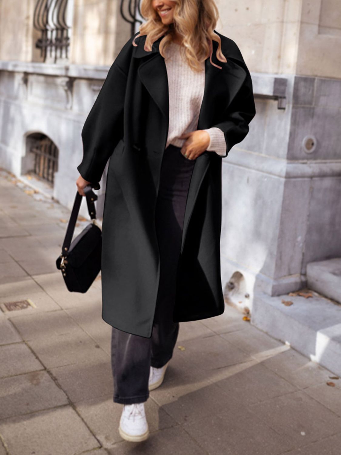 Black oversized wool-blend cocoon coat with wide lapels and a relaxed fit.