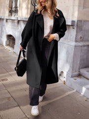 Black oversized wool-blend cocoon coat with wide lapels and a relaxed fit.