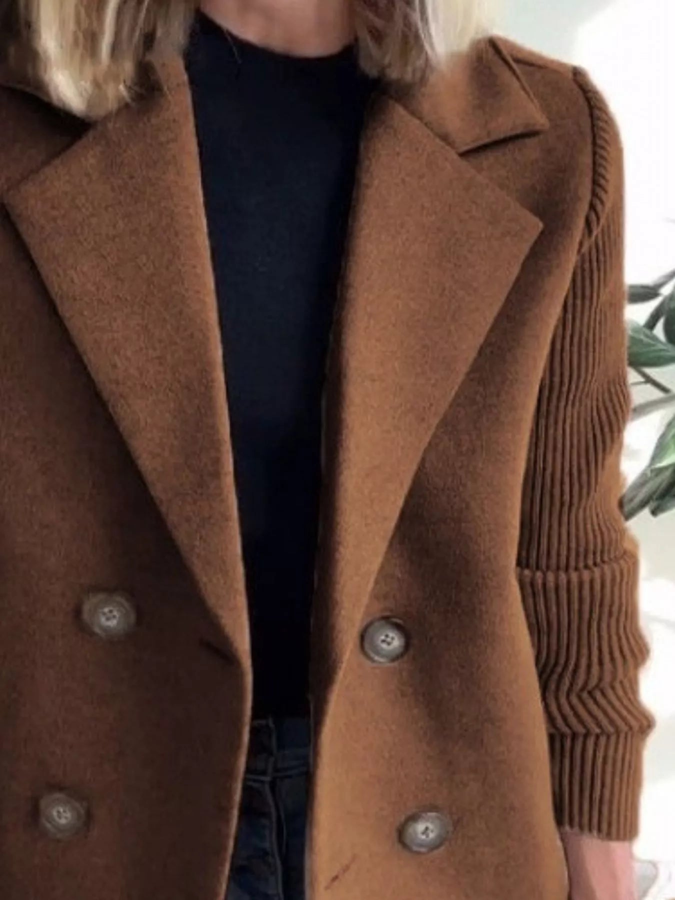 Brown double-breasted coat with knit sleeves and button details