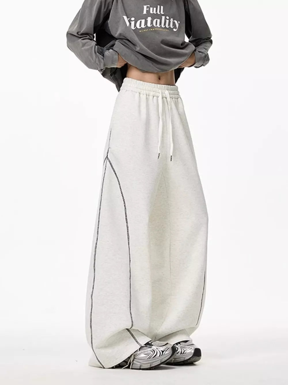 Light gray wide-leg drawstring sweatpants with contrast stitching detail