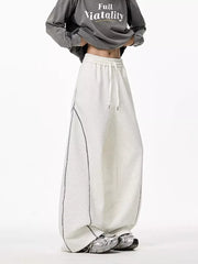 Light gray wide-leg drawstring sweatpants with contrast stitching detail