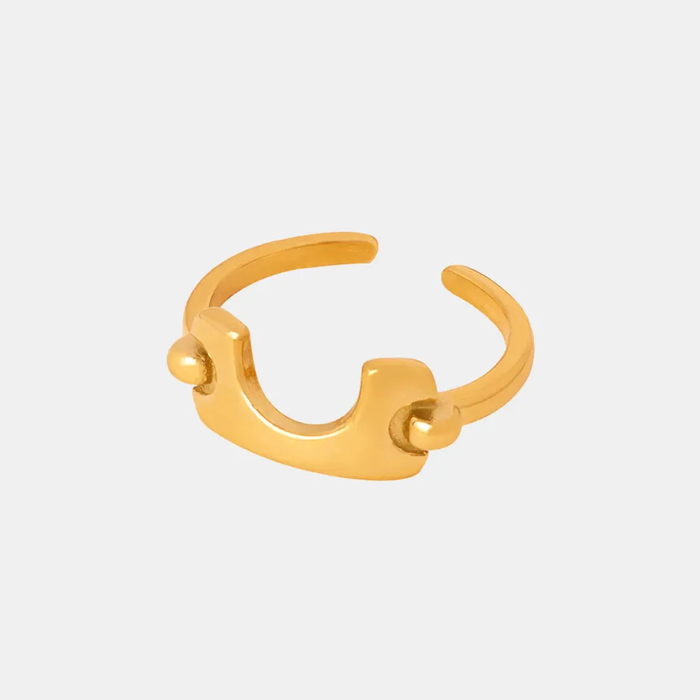 Sculptural gold open-ended ring with asymmetrical design and ball accents.
