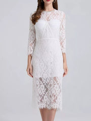 White lace midi dress with sheer sleeves and a sweetheart neckline detail.