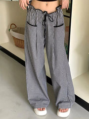 High-waisted wide-leg gingham pants with drawstring and black trim.