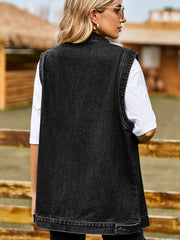 Sleeveless dark gray denim utility vest with button detail at hem