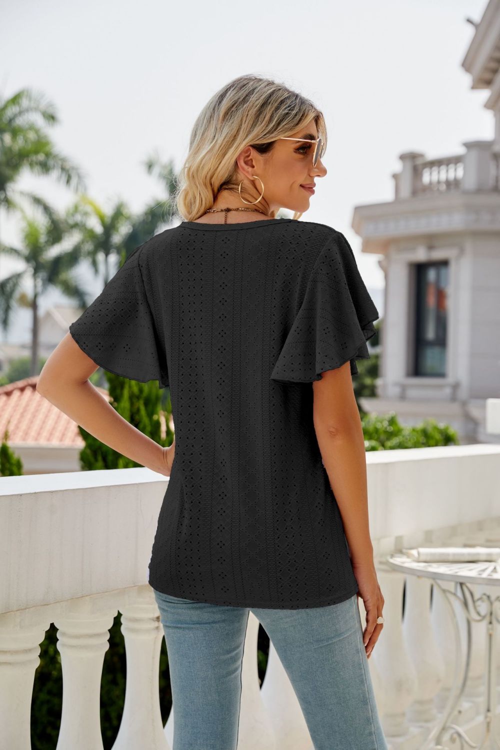 Black eyelet flounce sleeve crew neck top with textured detail