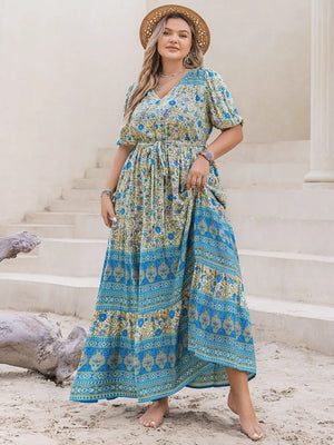 Bohemian floral maxi dress with tie waist, V-neck, short sleeves, and tiered skirt in blue and yellow.