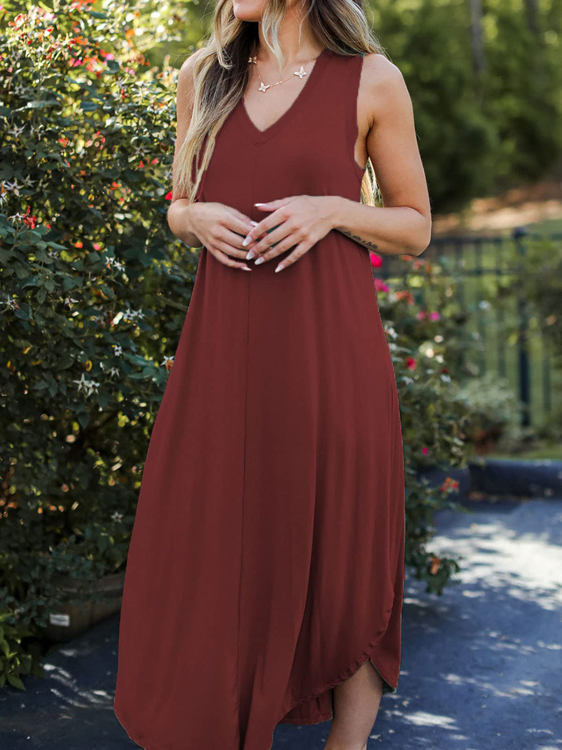 Burgundy sleeveless V-neck midi dress with asymmetrical hemline