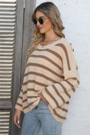 Apricot striped knit pullover sweater with button shoulder detail.